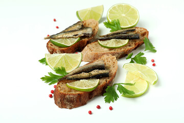 Delicious sandwiches with sprats on white background