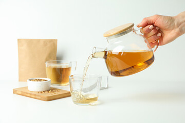 Concept of hot drink with buckwheat tea on white background