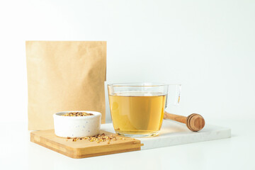 Concept of hot drink with buckwheat tea on white background