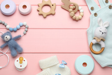 Cute baby stuff on pink wooden background, flat lay. Space for text
