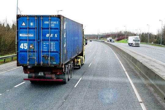 N6 road to Dublin, Ireland - 21.01.2022: Highway and traffic to the capital of Ireland from Galway. Lorry with cargo container. Travel and transportation.