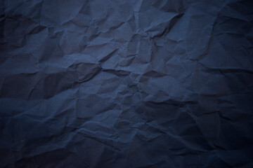 Textured crumpled black paper background.