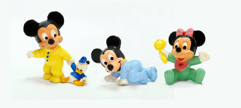 Babies Mickey and Minnie Mouse. Retro toy figure. Plastic doll. Vintage. Isolated. Cartoon character from Walt Disney Pictures Studios. Mickey is Minnie Mouse's boyfriend. Baby with Donald Duck plush.