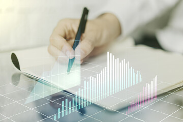 Double exposure of abstract creative financial diagram with hand writing in notebook on background, banking and accounting concept