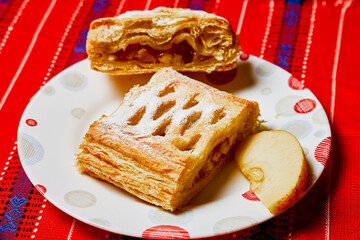An apple pie on a plate ready to be eaten