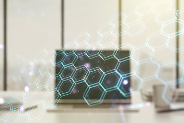 Creative concept of wireless technology with hexagon hologram on modern laptop background. Big data...