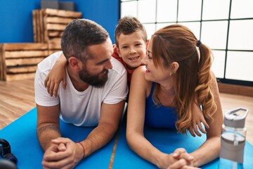 Obraz premium Family smiling confident lying on yoga mat at sport center