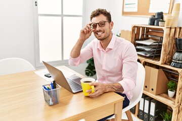 Young hispanic man smiling confident working at office