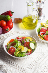Vegetable salad with cucumber, tomato, sweet pepper in a white plate