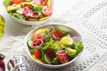 Vegetable salad with cucumber, tomato, sweet pepper in a white plate