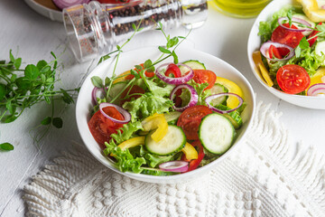 Vegetable salad with cucumber, tomato, sweet pepper in a white plate