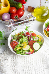 Vegetable salad with cucumber, tomato, sweet pepper in a white plate