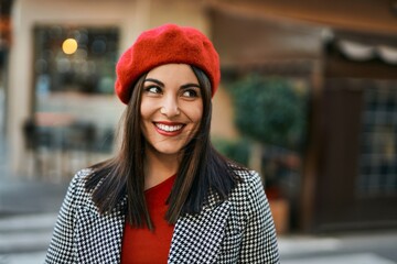 Young hispanic woman smiling happy standing at the city.