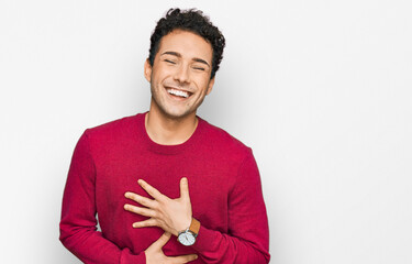 Young handsome man wearing casual clothes smiling and laughing hard out loud because funny crazy...