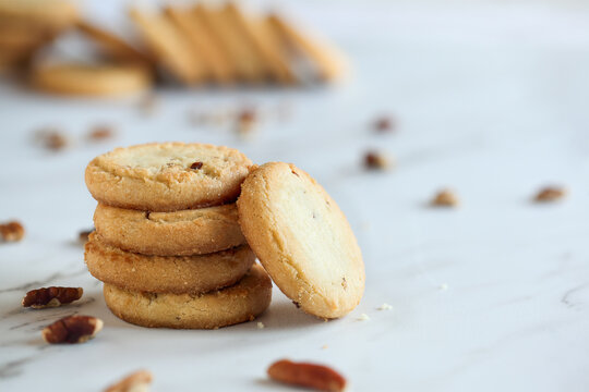 Stack of pecan sandies cookies. Selective focus with blurred foreground and background.