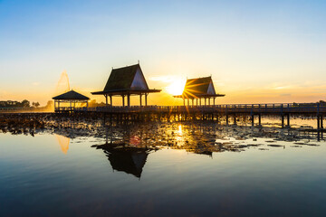 Fototapeta premium Sunset at the Pavilion on lake or pond or swamp of Bueng See Fai, Phichit, Thailand.
