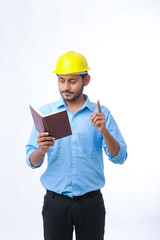 Young indian engineer wearing hardhat and watching diary