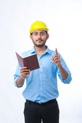 Young indian engineer wearing hardhat and watching diary