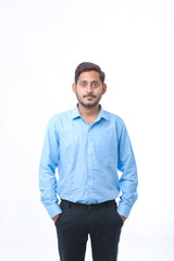 Young indian man standing on white background.