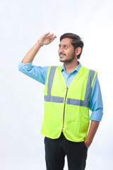 Young Indian engineer giving expression on white background.
