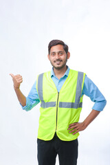 Young Indian engineer giving expression on white background.