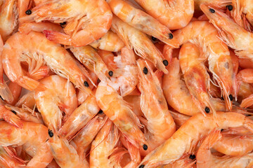 Unpeeled fresh shrimp on a white background.