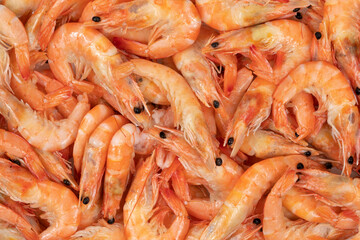 Unpeeled fresh shrimp on a white background.