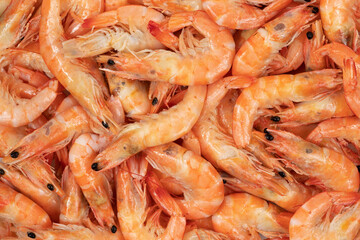 Unpeeled fresh shrimp on a white background.