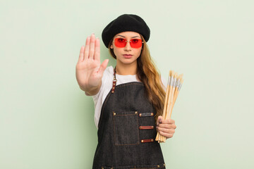 asian pretty woman looking serious showing open palm making stop gesture. artist concept