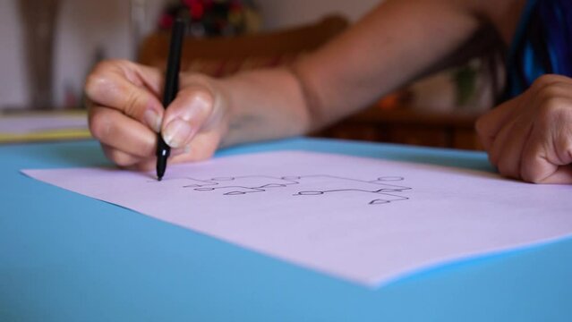 Crop View Of A Person Sketching A Genogram On White Sheet. Closeup
