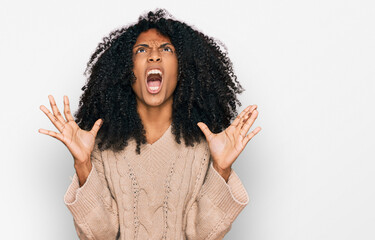 Young african american girl wearing casual clothes crazy and mad shouting and yelling with...