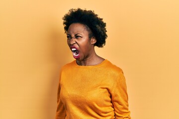 Fototapeta na wymiar Young african american woman wearing casual clothes angry and mad screaming frustrated and furious, shouting with anger. rage and aggressive concept.