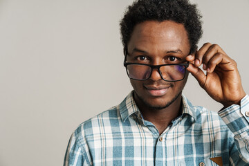 Fototapeta premium Young black man wearing eyeglasses smiling and looking at camera