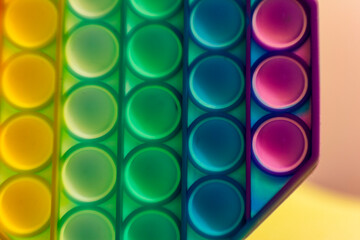 Close up shot of octagon pop it toy on colorful background. Indoors