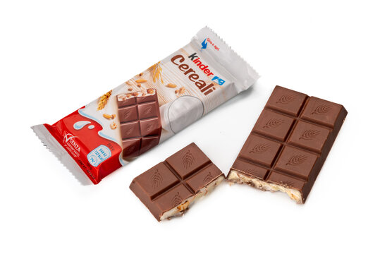 Alba, Italy - December 28, 2021: package of Kinder Cereali Ferrero with bar of milk chocolate stuffed with milk and puffed cereals isolated on white produced by Ferrero famous confectionery factory
