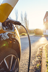Electric car plugged in outside house © Southworks