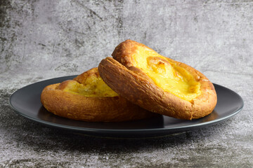 Sweet and traditional ensaimada covered with cream.