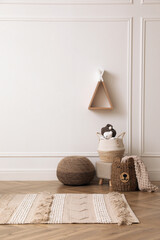 Cute child room interior with wicker baskets, toys and wigwam shaped shelf on white wall © New Africa