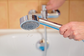 Hand holding modern shower head