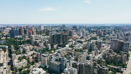 Fototapeta na wymiar Flying over the buildings of the big city. Aerial view of the cityscape