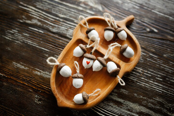 White acorns decor with a small red heart. Postcard for Valentine's Day, you are special, not like everyone else