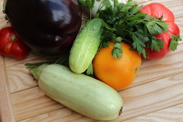 Tomato,, cucumber, zucchini on background of wooden boards. Organic vegetables.