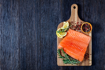 Fresh salmon fish fillet on wooden board