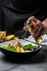 Freezer food prepare in process salad by chef hand in home kitchen Grilled chicken breast, pineapple, avocado, green rocket salad, lime and olive oil. banner, menu recipe place for text