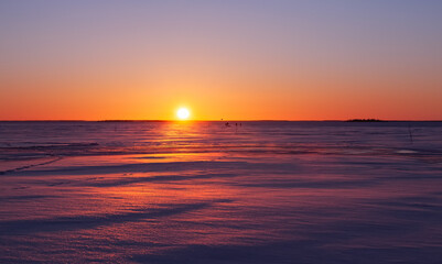 Winter landscape. Sunset over the frozen sea.
