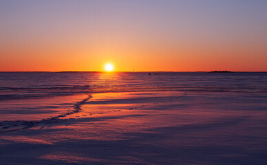Winter landscape. Sunset over the frozen sea.