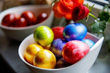 Homemade colored eggs for Easter. Coloring with different rainbow organic colors.