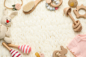 Fototapeta na wymiar Frame of different baby stuff on light knitted fabric, flat lay. Space for text
