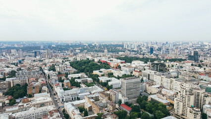 Flying over the buildings of the big city. Aerial view of the cityscape