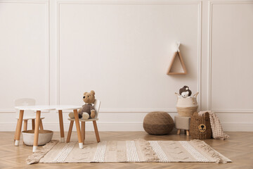Cute child room interior with furniture, toys and wigwam shaped shelf on white wall © New Africa
